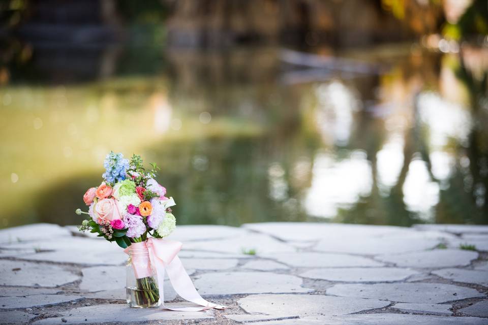 Pop of springtime colors from this bridal bouquet at a desert oasis.