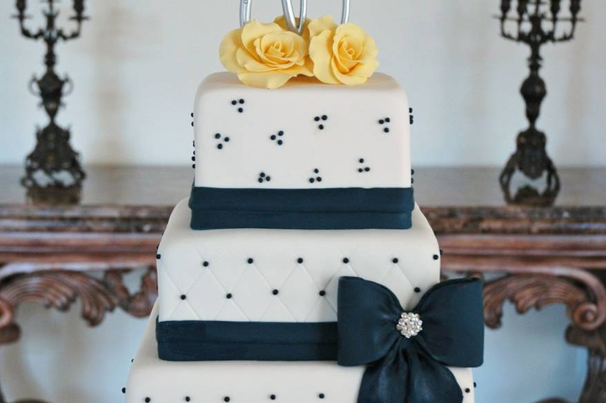 Classic elegance.  Navy ribbon with yellow roses, and silver monogram topper.