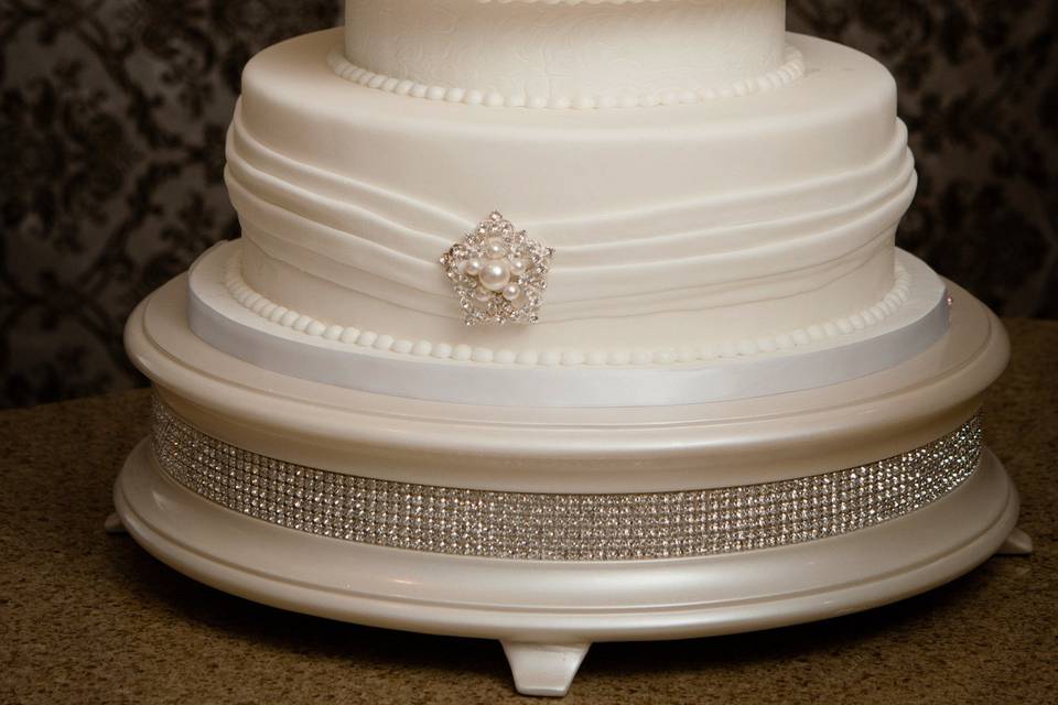 Sashes and Brooches.  An elegant and formal wedding cake.