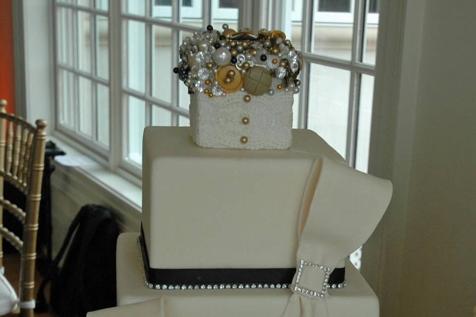 Square cake with single loop bows and rhinestone sliders and trim.  Custom topper.