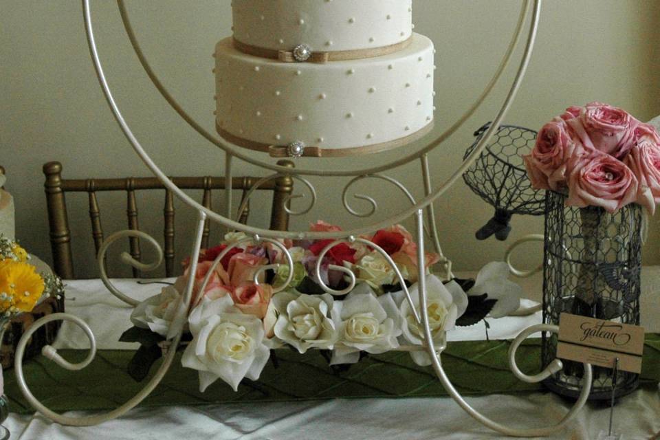 Chandelier cake, with offset swiss dots design, pearl brooches and sugar roses.