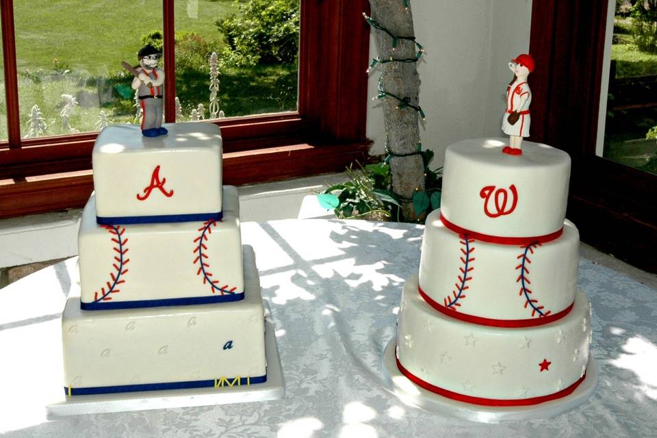 His and her wedding cakes.  Baseball themed wedding cakes for a Bride and Groom serious about baseball.  Coordinating toppers, Groom as batter and Bride as pitcher.