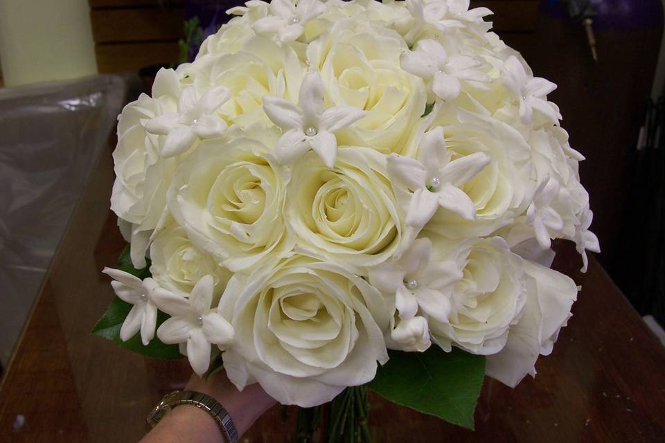 Clutch style bouquet of white roses and stephanotis
