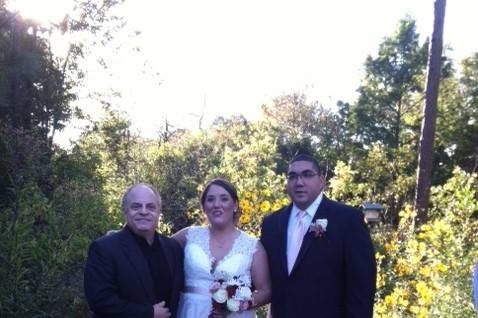 Bride and groom with officiant