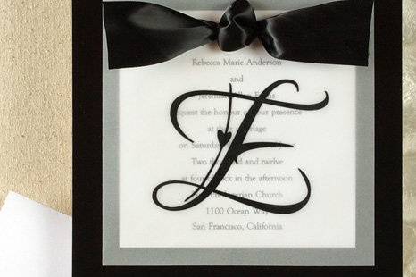 Sheer Initial Wedding Invitations
AV1184
The groom's last name initial takes center stage on a translucent overlay, while your invitation wording is printed on a square card. Its then placed against a shiny backer and tied together with a satin ribbon. This invitation makes an elegant statement.
Available in Multiple Colors
http://www.theamericanwedding.com/shopping/prod_detail/main.asp?pid=7108