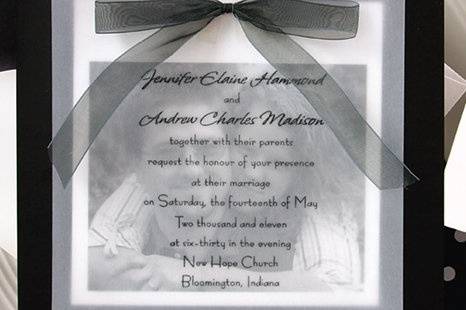 Picturesque Wedding Invitations
AV951
Your photo is printed on Bright White heavy cardstock, then your invitation wording is printed on a translucent overlay in the raised ink and type style of your choice. Both are placed on a glossy Black backer using glue dots (included), then topped off with your choice of a sheer Black or White organza bow. Plain white accessory cards complete the look.
http://www.theamericanwedding.com/shopping/prod_detail/main.asp?pid=5391