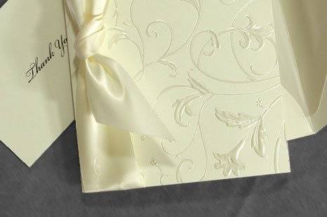 Polished Perfection Wedding Invitations
AV1196
Creamy Ecru vellum forms the background for this glamorous invitation. Pearl embossed floral and vines adorn the front of the single fold card. A lush satin ribbon is tied along the fold. For your own touch, why not add ribbon to match your wedding colors? Matching plain accessory cards are simple and elegant.
http://www.theamericanwedding.com/shopping/prod_detail/main.asp-pid-7148