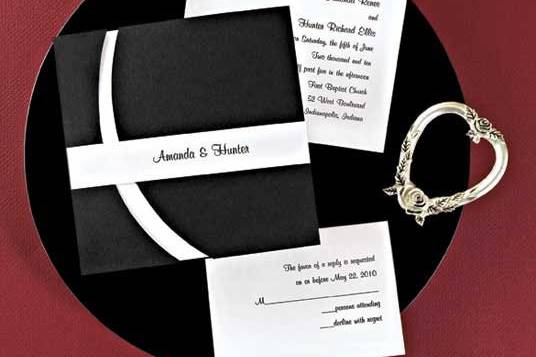 Bold Curves Wedding Invitations
AV597
This unique presentation is an American Wedding exclusive! Your invitation wording is printed right-justified (as shown) in raised ink on a smooth heavyweight card. The card is tucked inside a sophisticated die-cut Black folder and topped with a personalized band printed in matte ink.
http://www.theamericanwedding.com/shopping/prod_detail/main.asp-pid-3368