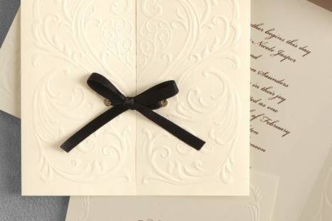 Versailles Wedding Invitations
AV1300
A romantic heart surrounded by filigree is richly blind embossed on this invitation. Untie the satin bow and open the card to reveal your words of invitation.
http://www.theamericanwedding.com/shopping/prod_detail/main.asp-pid-7005