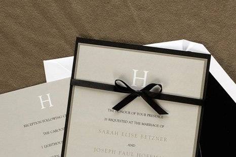Attractive Initial Wedding Invitations
AV1209
This taupe bordered invitation features your new last name initial at the top and your words of invitation printed below. A black backer and ribbon finish the look of this elegant wedding invitation.
http://www.theamericanwedding.com/shopping/prod_detail/main.asp-pid-7243