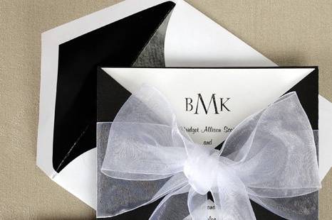 Tied With Love Wedding Invitations
AV1101
A heavyweight Black wrap envelopes a White square card personalized with your initials and words of invitation. It all ties together with a wide sheer ribbon.
http://www.theamericanwedding.com/shopping/prod_detail/main.asp-pid-6619
