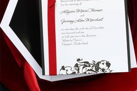 Prestige Wedding Invitations
AV935
A black, heavyweight card forms the backdrop for a single panel card. The card features an elegant black leaf design that frames your words of love. A pretty red ribbon holds it all together. An elegant and sophisticated choice for the modern couple.
http://www.theamericanwedding.com/shopping/prod_detail/main.asp-pid-5753