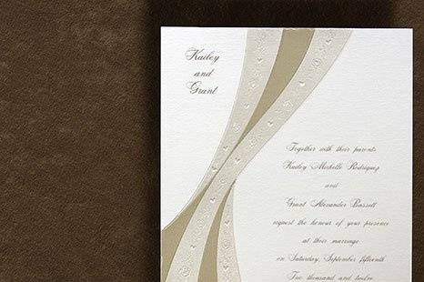 Streams of Love Wedding Invitations
AV1056
Pearl embossed ribbons, accented with delicate roses and hearts, form a unique design on this unique invitation.
http://www.theamericanwedding.com/shopping/prod_detail/main.asp-pid-5908