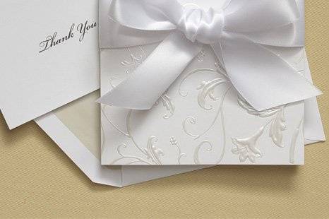 Scrolled Romance Wedding Invitations
AV1221
The die-cut edge of this posh White invitation is adorned with black foil scrolls. Once the scrolls meet, they form romantic hearts. Your words of invitation are printed inside and everything gets tied together with Black satin ribbon. If you wish, you may add your own ribbon to personalize the look.
http://www.theamericanwedding.com/shopping/prod_detail/main.asp-pid-7248