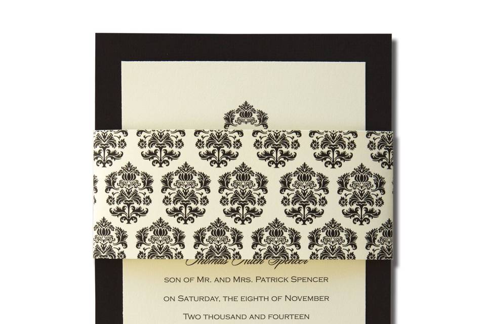 Bliss AV1018
Make a bold statement with these elegant black and white invitations. Your first names form the backdrop for your invitation wording on a single panel white card accented with two vertical black stripes. The card slips inside a personalized black band accented with two vertical White stripes. A truly unique presentation!