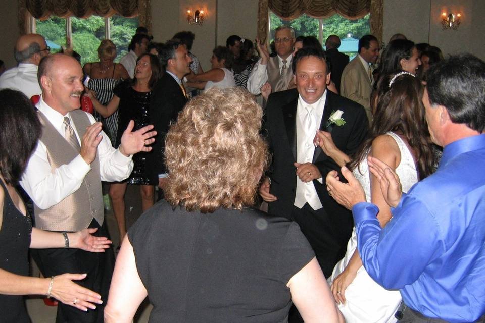 Newlyweds and their guests dancing