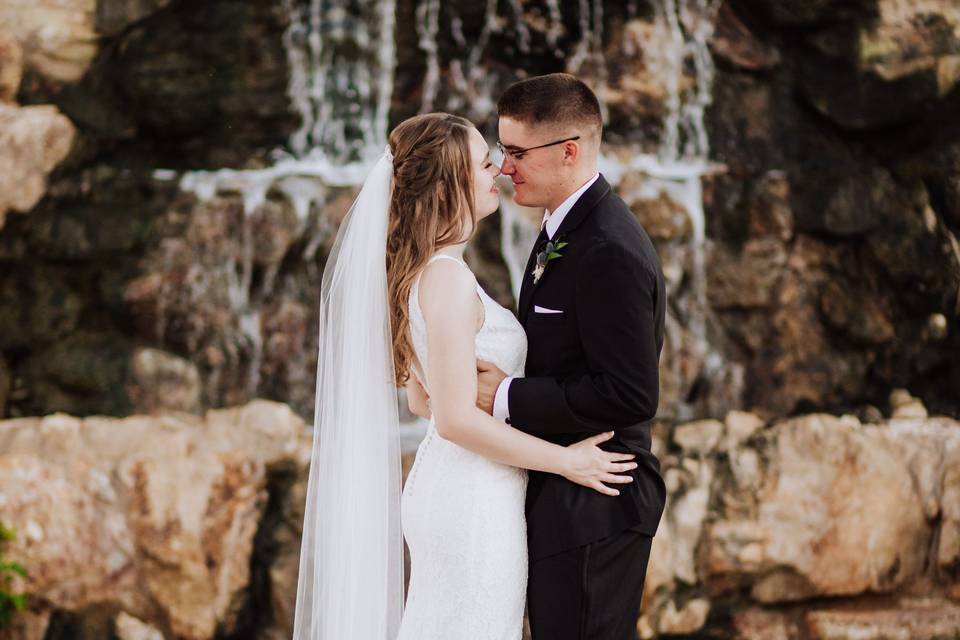 Bride and groom in front of waterfall