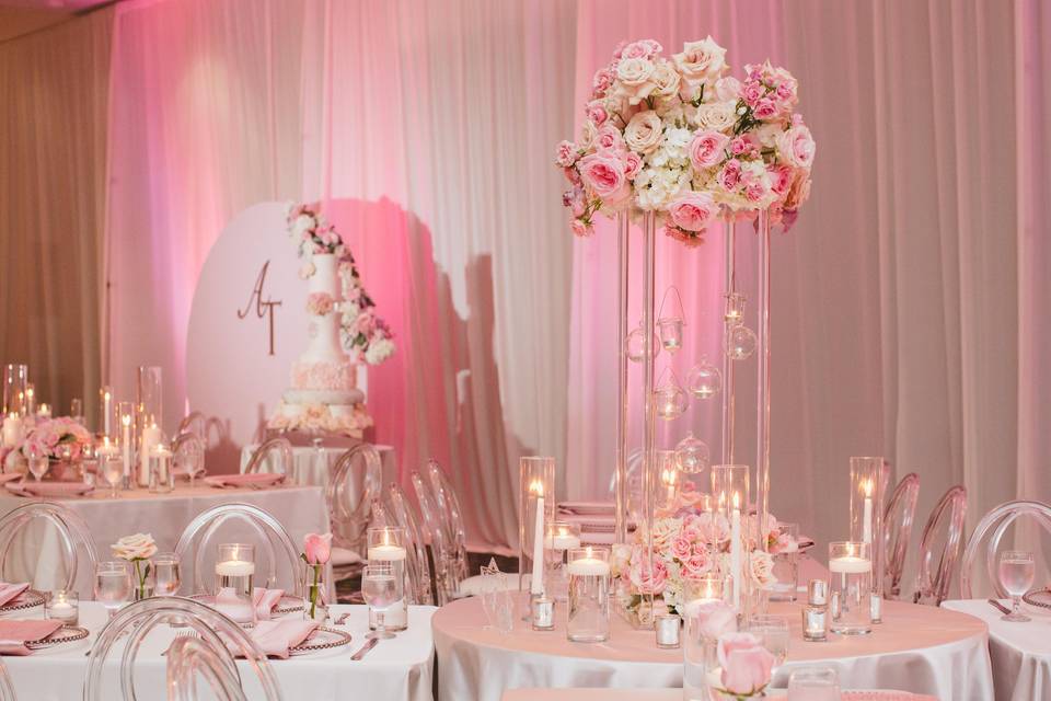 Raised centerpieces and pink uplights