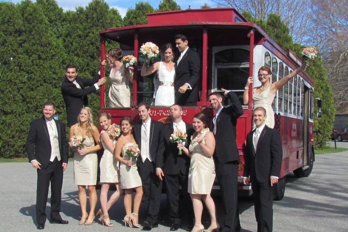 Newlyweds, bridesmaids, and groomsmen on the trolley