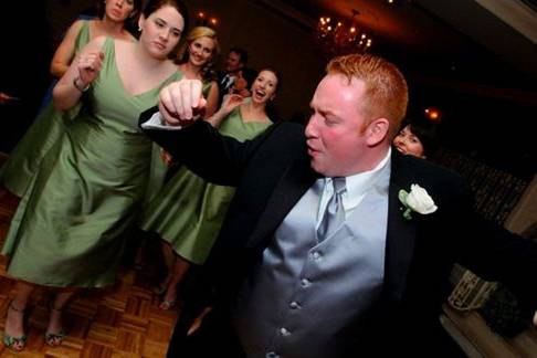 Dancing groom and bridesmaid