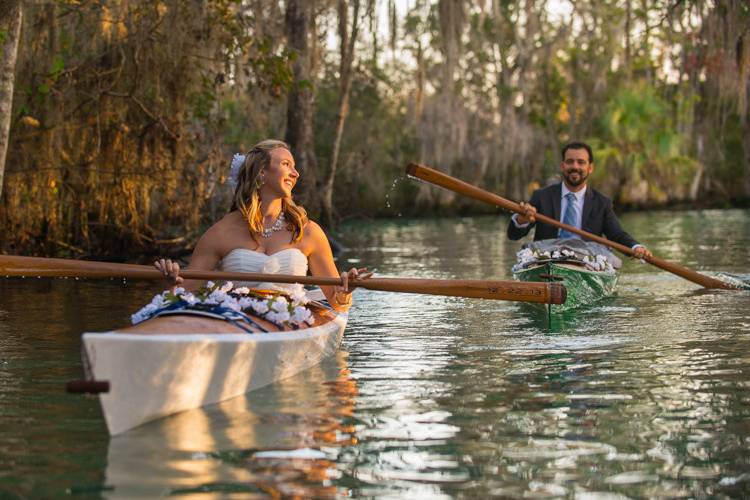 Bride and groom on kayaks