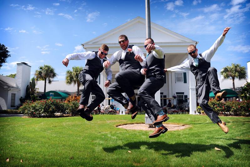 Jump shot of groomsmen and groom