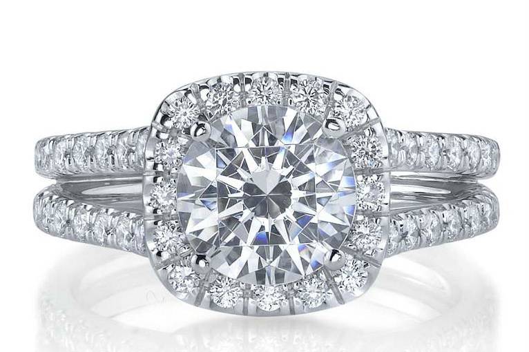 This is a stunninfg round diamond halo engagement ring with a split shank setting available at Diamond Exchange Dallas in Dallas, TX.