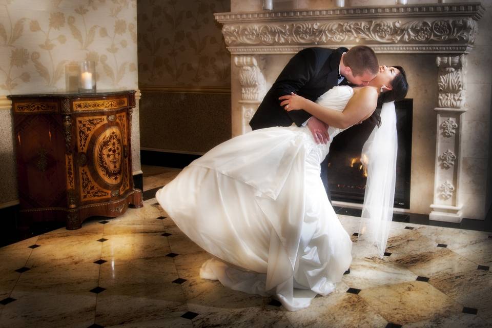A romantic, playful photo by the fire place.