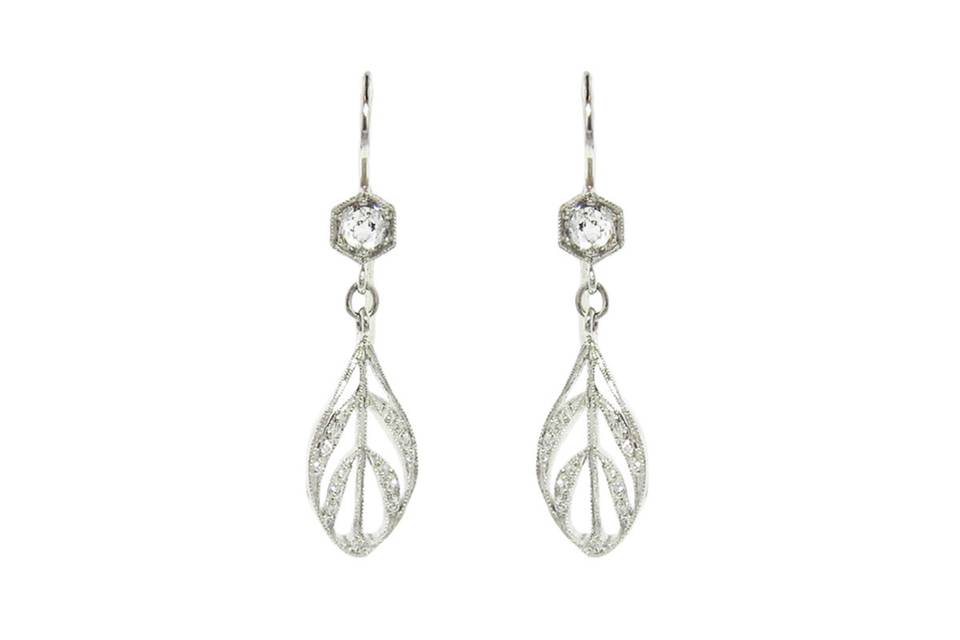 A gorgeous statement earring from Cathy Waterman. Set in platinum, these earrings feature sparkling diamonds set in her classic hexagon setting with etched detail around the edge. The large diamonds are accented with a peacock feather drop that has lovely movement and is detailed in tiny diamonds. The diamonds total .54 carats. The earrings measure 1 3/8
