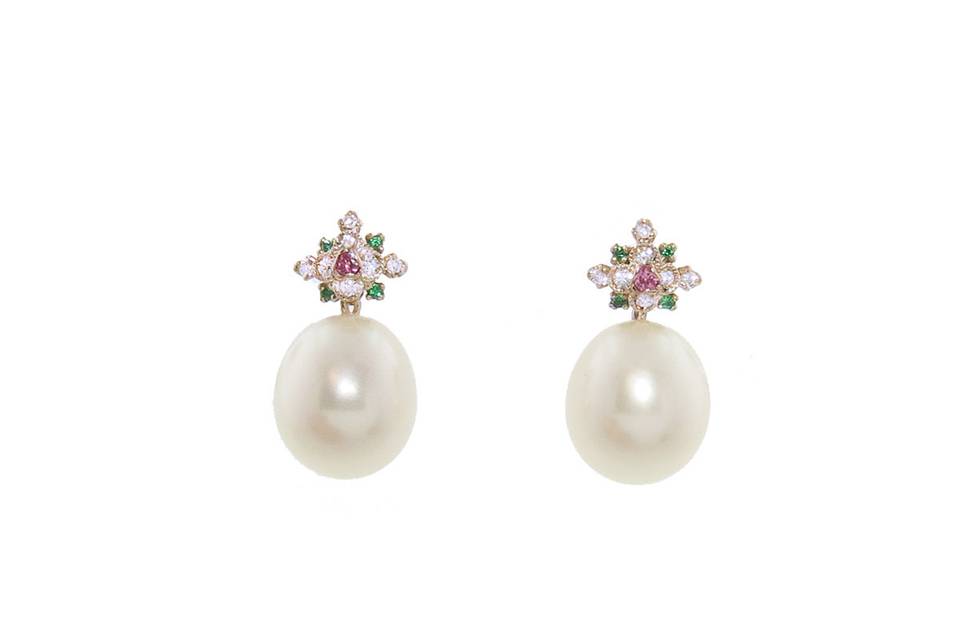 These gorgeous earrings from designer Kataoka are detailed in 18 karat rose gold and feature tiny emeralds, pink sapphires, and diamonds individually set in a cluster atop a pearl. The earrings measure 9/16