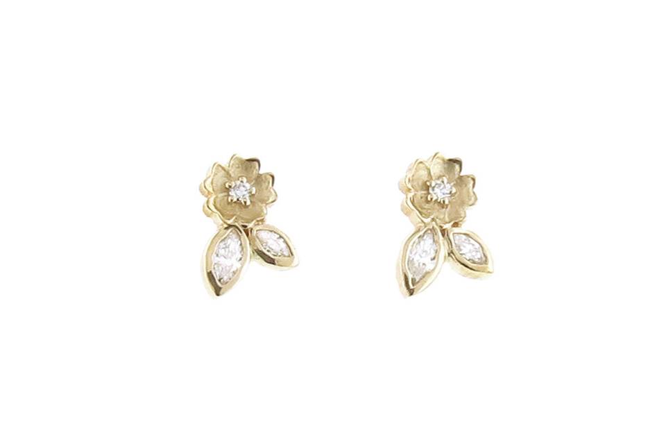 These delicate studs from Megan Thorne are composed of 18 karat yellow gold, a detailed flower with leaves featuring diamond center accents for an added touch of sparkle. They measure 3/8