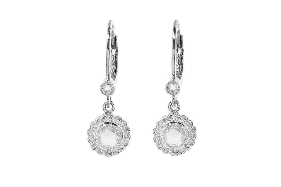 These dainty earrings from Sethi Couture are detailed by hand in 18 karat white gold and feature rose cut diamond center framed in a scalloped edge with diamonds. They measure 1/2