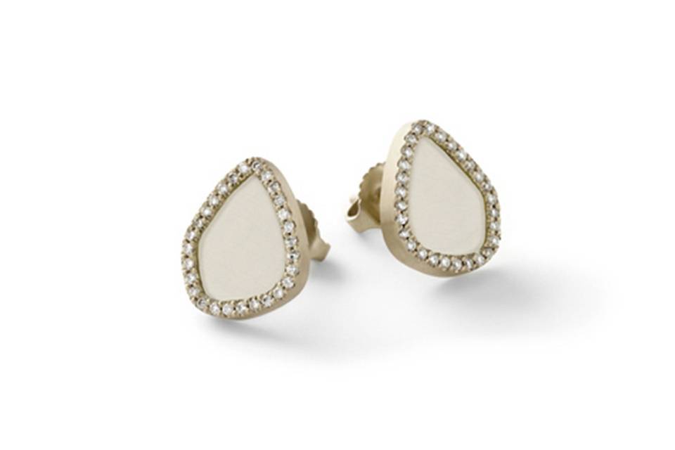 These beautiful studs from Monique Péan have slices of fossilized walrus ivory set in recycled 18 karat white gold. Each earring is framed in white diamonds and measure 1/2