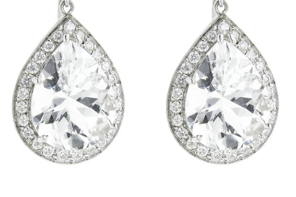 These substantial earrings from designer Andrea Fohrman are fashioned in 18 karat white gold and showcase large pear-shaped rock crystal stones framed in bright diamonds. The jewelry measures 1