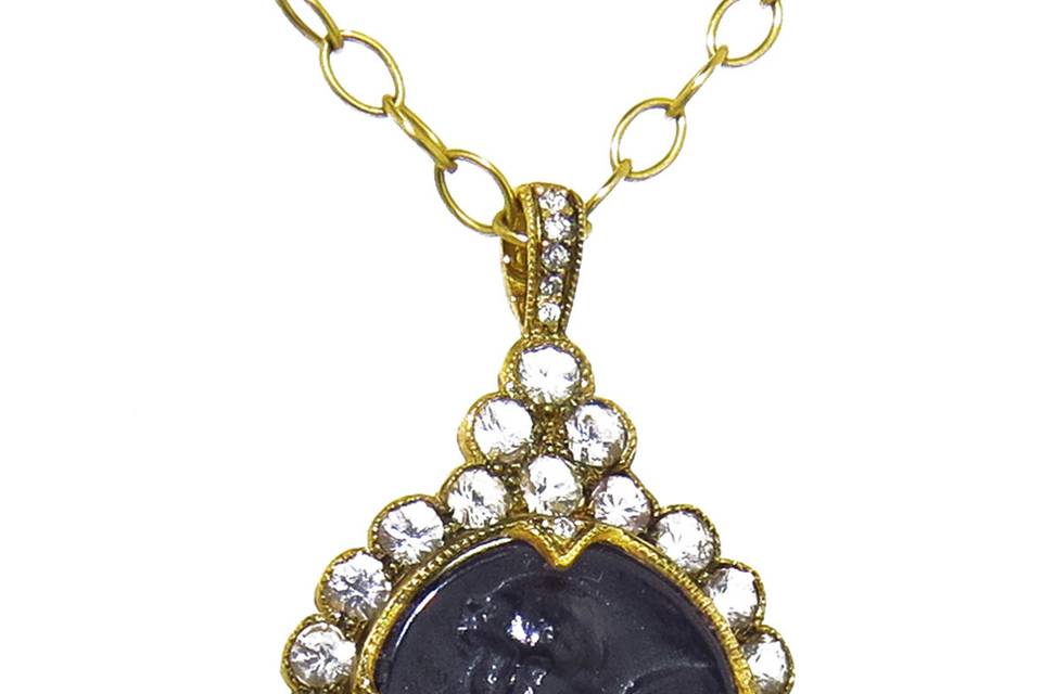 This elegant charm from Cathy Waterman has an old world aura, set in 22 karat gold with amazing, hand-crafted detail. A scalloped frame of bezel set white sapphires surrounds an etched opaque black glass intaglio, resting in tiny, diamond accented, thorn prongs. The loop on the charm is embellished with diamonds, creating a length of 1 3/8