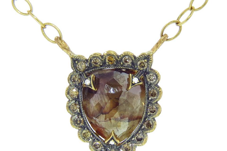 This gorgeous pendant from Cathy Waterman is a one-of-a-kind stunner featuring a 4.30 carat, caramel-colored rustic diamond. The center piece rests in a scalloped frame shield of cognac diamonds. It measures 5/8