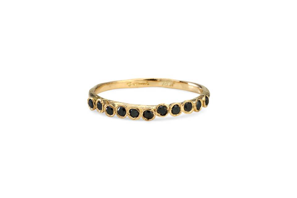 Each ring from designer Satomi Kawakita is handmade with impeccable precision. This raised black diamond band, crafted from 18 karat yellow gold, is no exception. Detailed and lovely in a ring stack.