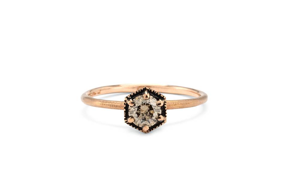 This brown diamond ring from Satomi Kawakita packs so much detail into a small stacking ring! The hexagon diamond center has six gold beads at its edge and totals .33 carats. It rests on a thin band with a matte finish and is perfect for your every day stack.