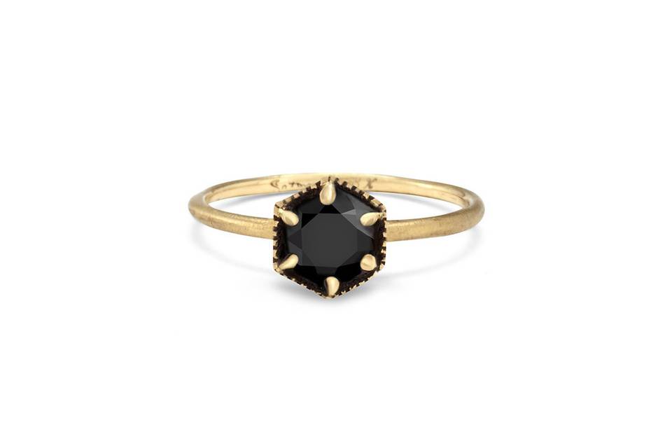 This black diamond ring from Satomi Kawakita packs so much detail into a small stacking ring! The hexagon diamond in the center has six gold beads at its edge and totals .30 carats. It rests on a thin band with a matte finish in 18 karat yellow gold and is perfect for your every day stack.