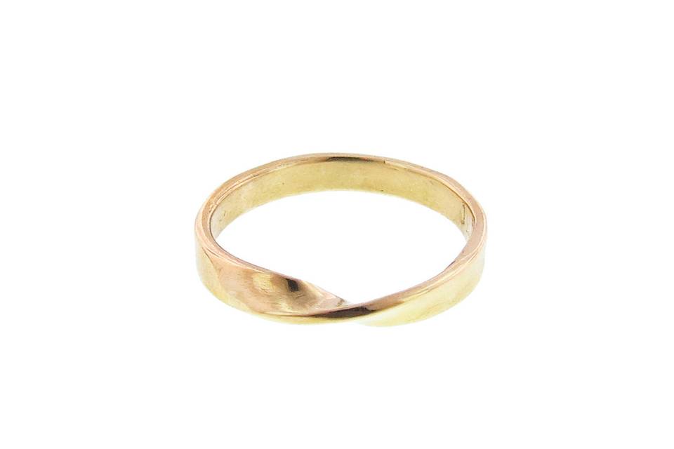 This wide ring from Yayoi Forest puts a twist on a simple band. This wide band is 14 karat yellow gold.