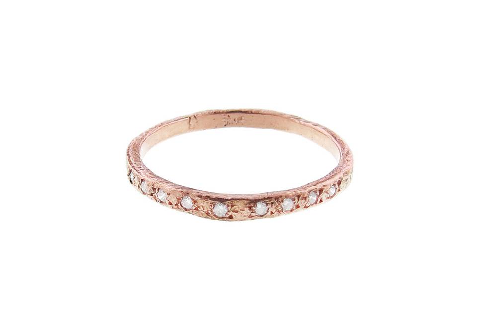 This rose garden band from Yayoi Forest is 14 karat rose gold and has a graduated row of diamonds in the front. The band is perfect for stacking.