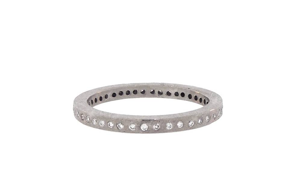 This simple stacking band from Todd Reed is composed of textured palladium with brilliant cut white diamonds set all of the way around. Diamonds share a total weight of .204 carats and the ring is a size 6 1/2.