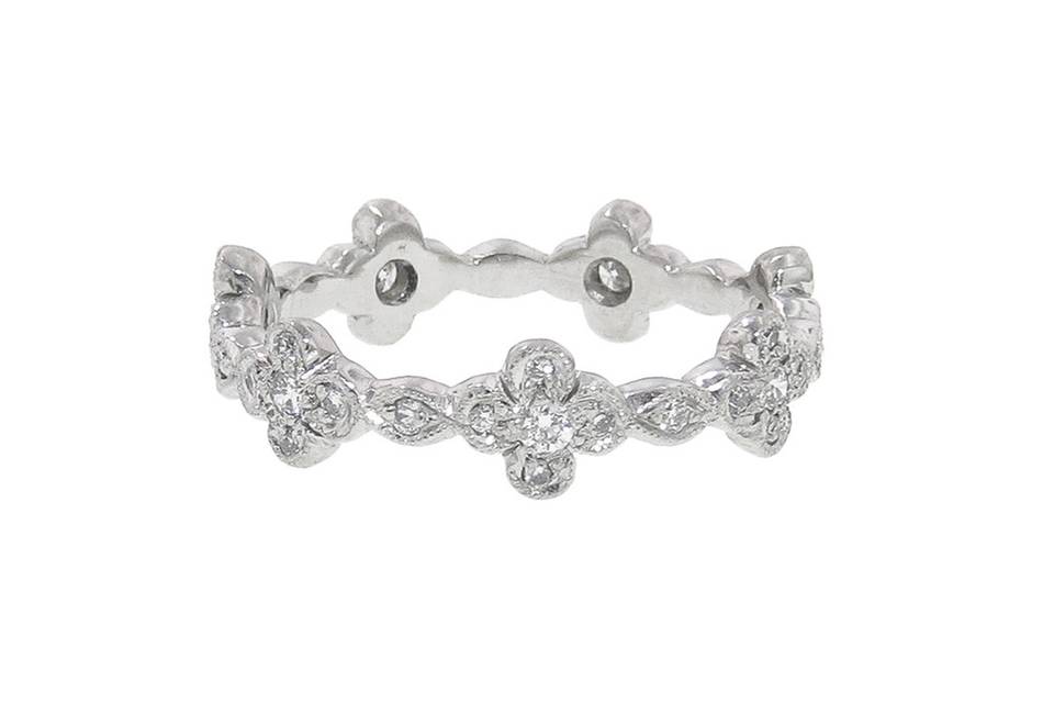 From jewelry designer Cathy Waterman, this delicate band is the perfect addition to your everyday stack, her classic four petal design spaced with a tiny marquis station. The band is composed of platinum and is detailed with sparkling diamonds. It measures 3/16