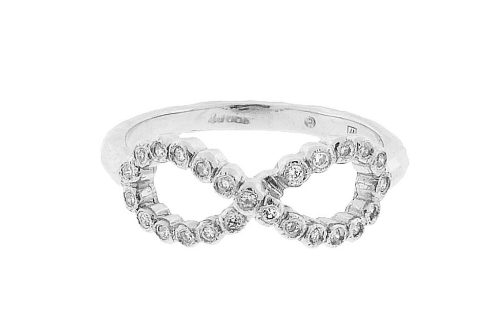 Another wonderful new ring from Cathy's platinum and diamond collection. With bezel set diamonds, this band twists to create a subtle, sweet infinity of love. Center measures 1/4