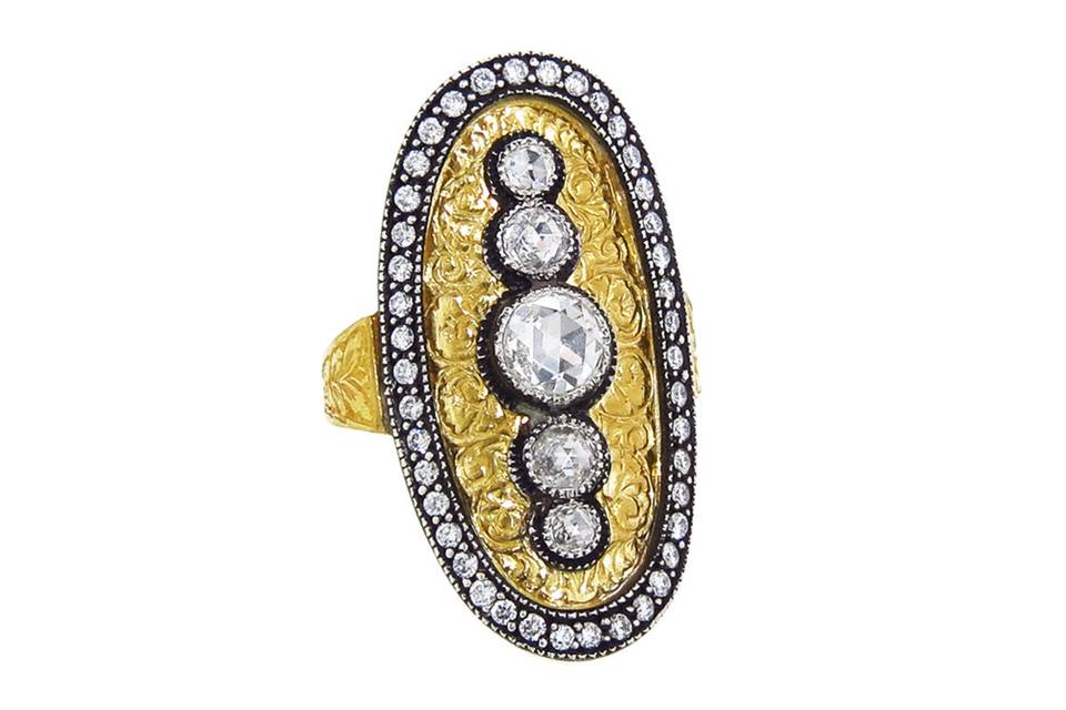 This fabulous ring from Arman is composed of 22 karat yellow gold with delicate etching an oxidized sterling silver edging. The ring features five, rose cut diamonds in the center that total .77 carats and a diamond pave border that totals .42 carats. The top measures 1 1/2
