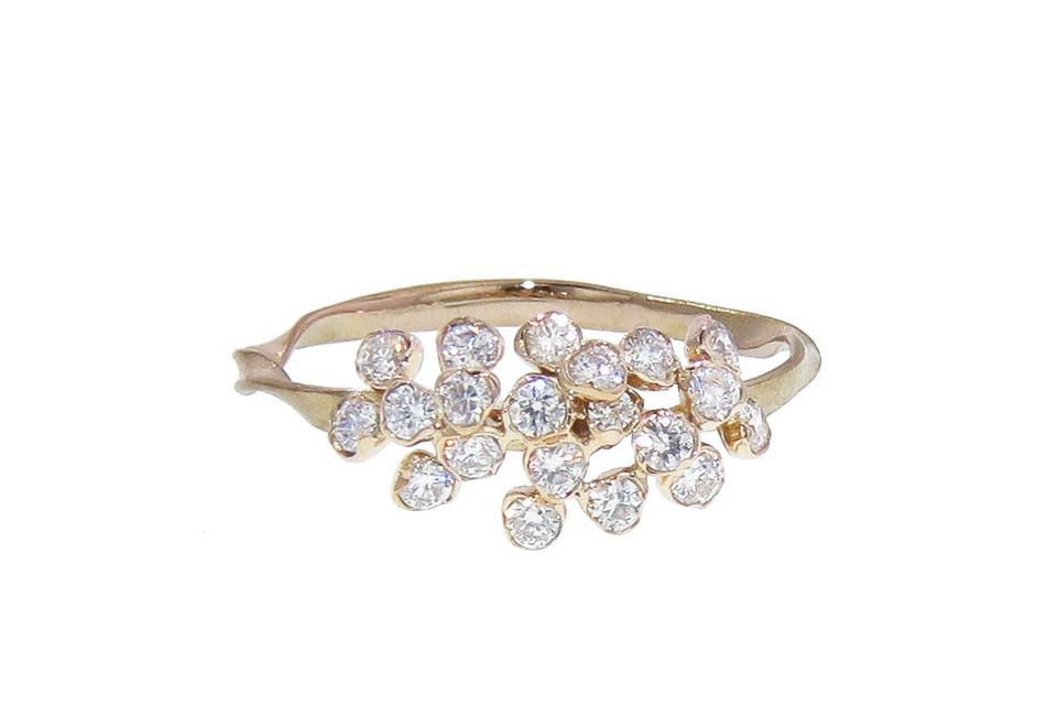 This gorgeous ring from Kataoka is composed of 18 karat rose gold with amazing detail. A cluster of individually set diamonds that totals .40 carats rests on a thin twisted band and adds a touch of sparkle to your everyday stack.