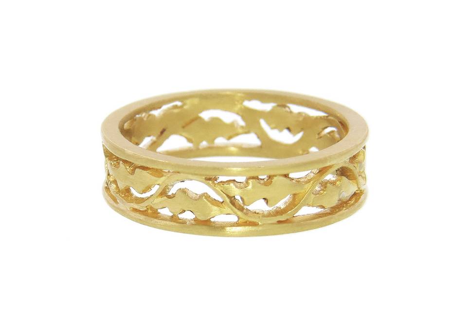 This lovely band from designer Cathy Waterman is composed of 22 karat yellow gold with a wonderful, subdued finish. The band features a vine and leaves recessed between two outer bands, for a total width of 3/16