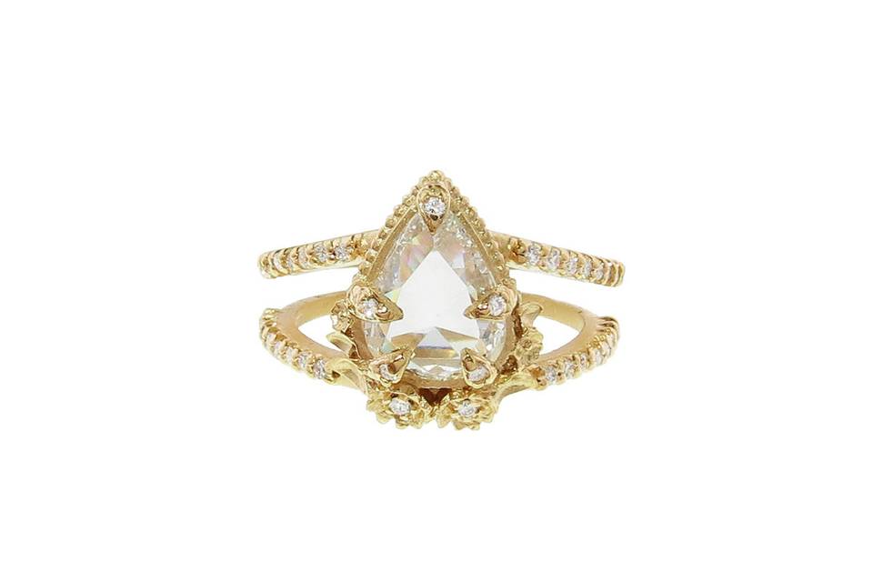 A timeless treasure from Megan Thorne, this ring has an allure that will draw every eye in the room. Set in 18 karat yellow gold, this ring is features a rose cut pear diamond that totals 1.71 carats and is set in Megan's unique leaf prong setting. Sparkling diamonds trim this double-band ring and altogether total .21 carats. This beautifully detailed ring is sure to become a favorite!
