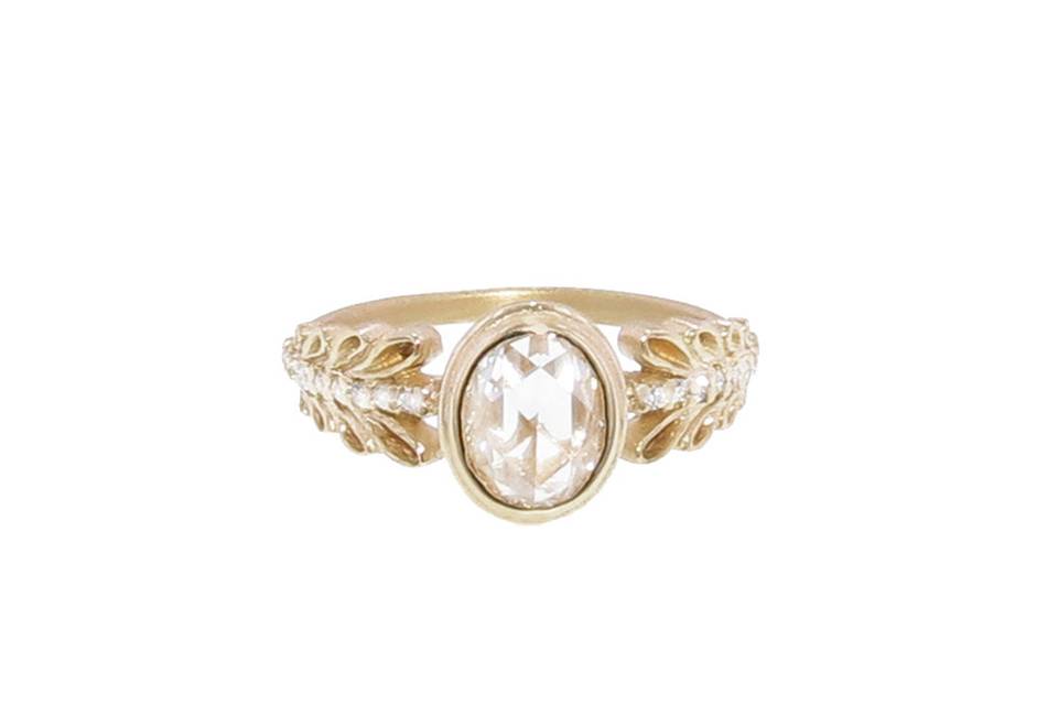 This Marina Garland Pave Ring from designer Megan Thorne is amazing! The center stone is a .93 G-H/S-I rose cut oval diamond with garland pave diamond detailing on either side. In 18 karat yellow gold, the detailing is so beautiful, it is certain to become a family heirloom.