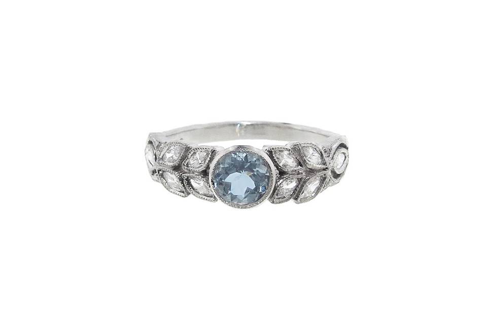 Simply stunning from Cathy Waterman, this round aquamarine stone is set in platinum and has a carat weight of .42 carats. The band is composed of bright marquis diamond leaves, measuring 1/4